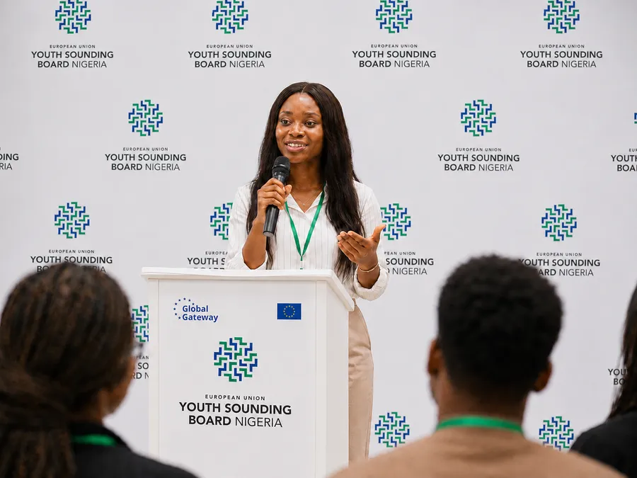 YSB Nigeria — speaker at the branded podium with Global Gateway and EU flag backdrop